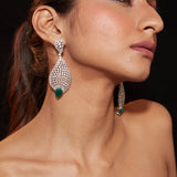 Rhodium Plated Zircon Studded With Green Synthetic Emerald Stone Dangle Earrings