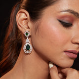 Rhodium Plated Zircon Studded With Green Synthetic Emerald Stone Dangle Earrings